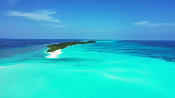 Aerial view scenery of idyllic coastline beach break by turquoise lagoon and white sandy background 