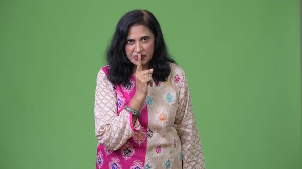 Mature Beautiful Indian Woman with Finger on Lips