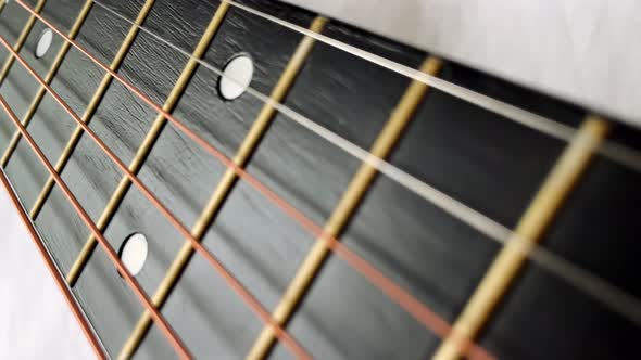 Zoom in Shot of Black Frets Fretboard Acoustic Guitar String