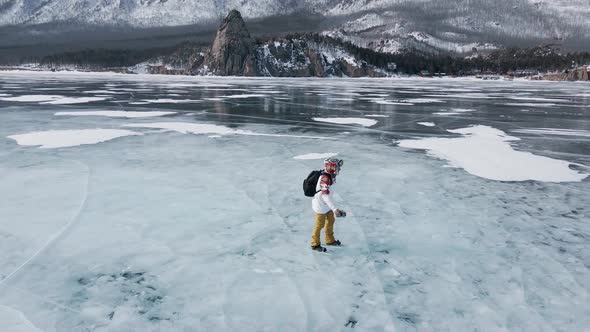 Aerial View of Man Skating on Lake Baikal Covered By Ice