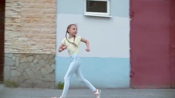 Scared Girl Teenager Running on City Street in Building Background and Looking Around