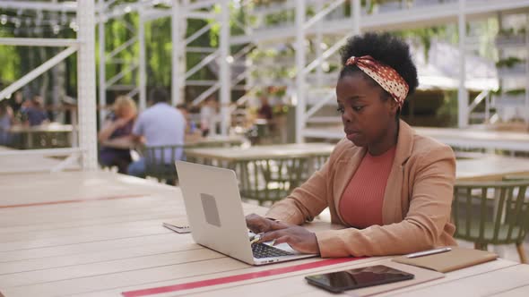  Black Businesswoman Working on Laptop in Public Place