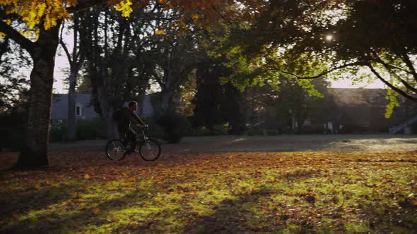 College student on campus riding bicycle