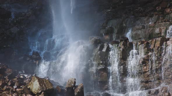 Waterfall crashes on the cascade stones