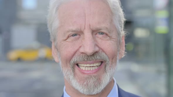 Close Up of Smiling Old Businessman