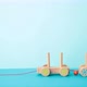 Wooden toy train moves on blue background. Stop motion - VideoHive Item for Sale