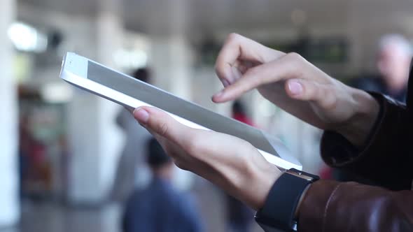 Business Woman Uses A Tablet In Airport Terminal