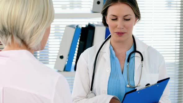 Female doctor interacting over a report with a patient