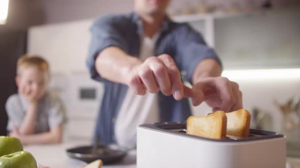 Father Making Toasts for Breakfast