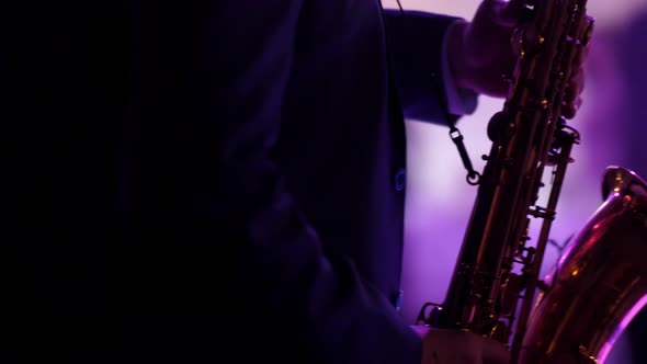 A Saxophonist in a Jacket Plays Music