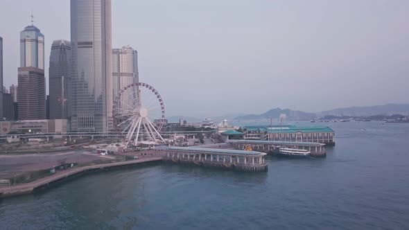 Hong Kong Observation Ferris Wheel and Central downtown harbourfront. Aerial drone view