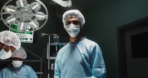 A Team of Surgeons Perform an Operation in a Bright Operating Room