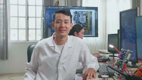 Development Facility:  Asian Man Smiling Charmingly Looking At Camera