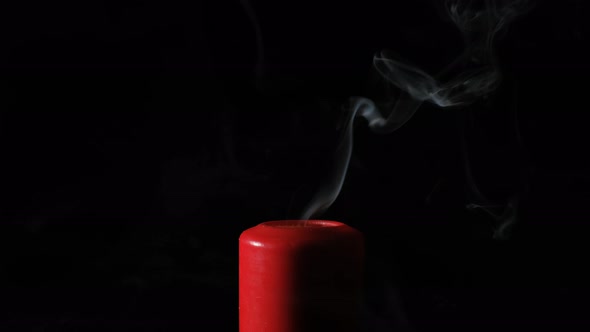 Smoke From Red Candle on the Black Background