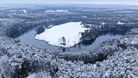 Snowy forest, cold winter river in winter.