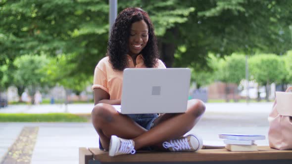 African Student Girl with Laptop and Books in City