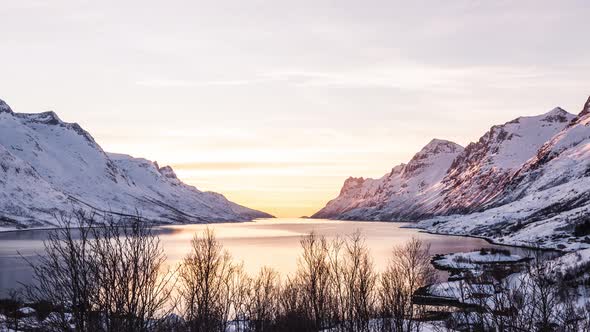 Time lapse of a sunset with the lights fading in Ersfjordbotn / Ersfjord in northern Norway.