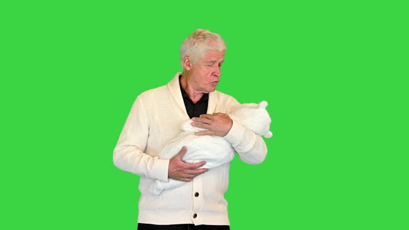 Grandfather Standing and Holding Grandson on a Green Screen Chroma Key