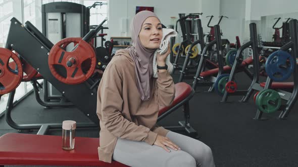 Portrait of Cheerful Woman in Hijab Resting after Gym Workout