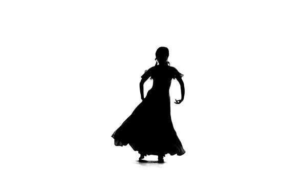 Dancer Turns in an Incendiary Dance of Argentine Flamenco. White Background. Silhouette