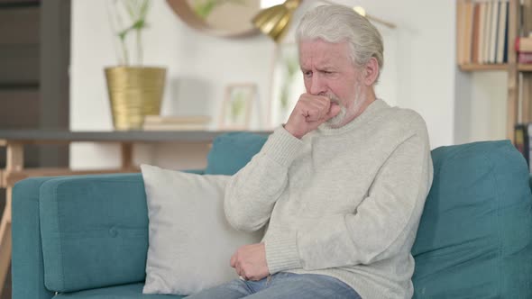 Sick Old Man Coughing Sitting on Sofa 