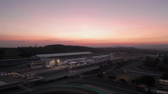 Aerial view of Hungaroring paddock filled with trucks, after sunset