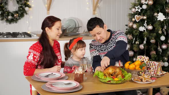 Man Cuts Chicken to Feed Family Sitting at Holiday Table