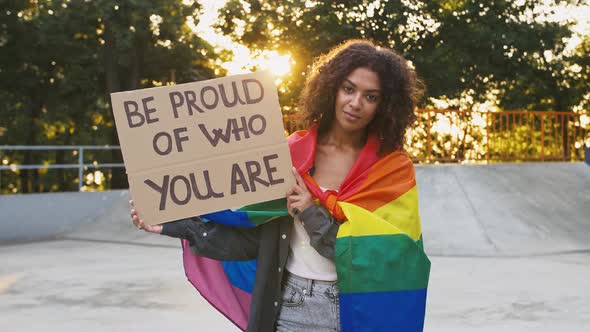Darkskinned Woman in Colorful LGBT Pride Flag