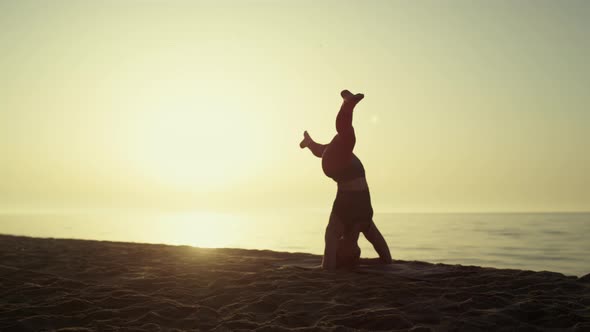 Yoga Woman Making Headstanding at Sunset