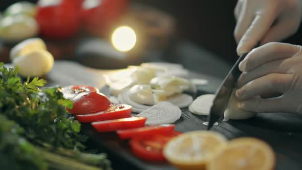 Chef Cutting Up an Onion with a Knife