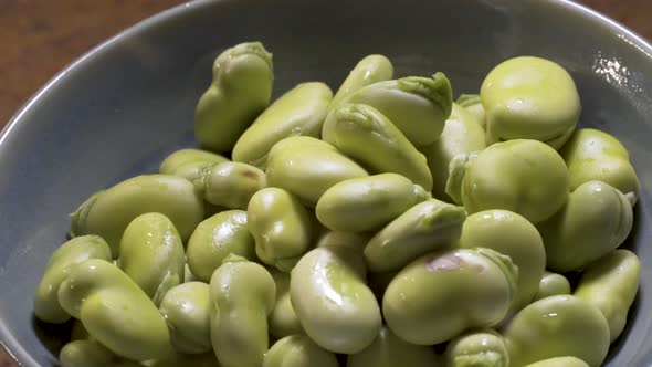 Shelled fava beans in a pretty, hand crafted turquoise bowl.