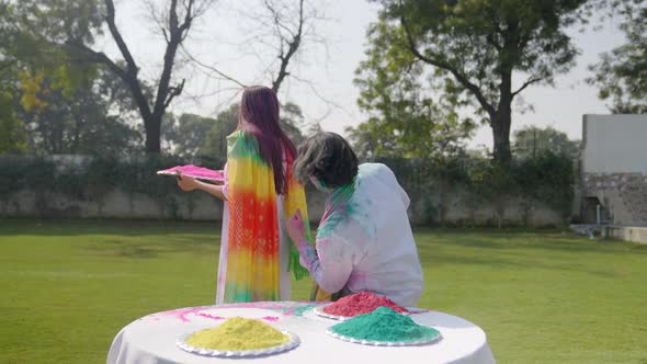 Indian man playing Holi with her partner