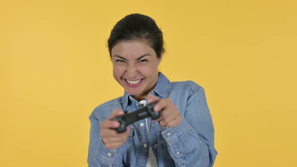 Indian Woman Playing Video Game, Yellow Background 
