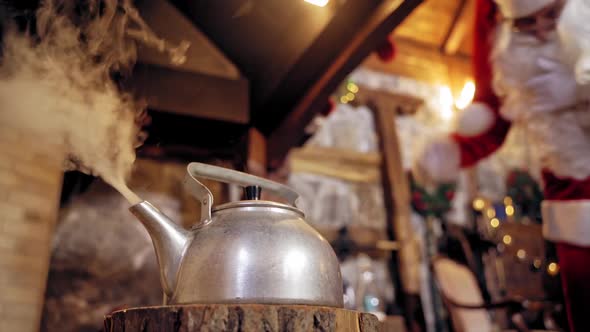 Santa Claus making tea. Santa Claus opening the lid of the kettle