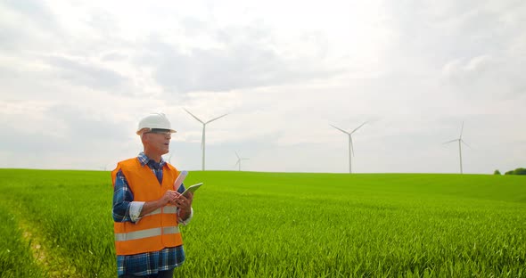 Male Engineer Working While Holding Blueprint