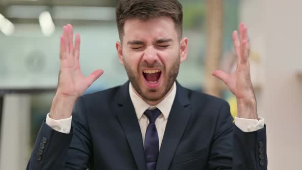 Angry Young Businessman Shouting Screaming