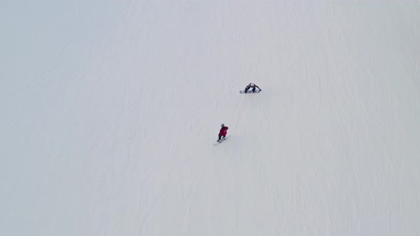 people skiing in the thick snowy trail of Bialy Potok Zima. Aerial