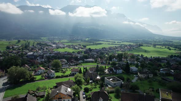 Aerial View of Liechtenstein with Houses on Green Fields in Alps Mountain Valley