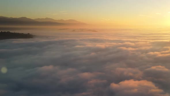 Aerial of the sunrise above the clouds