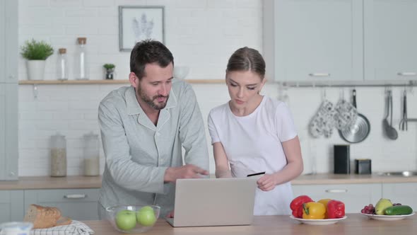 Woman and Man Making Online Payment on Laptop