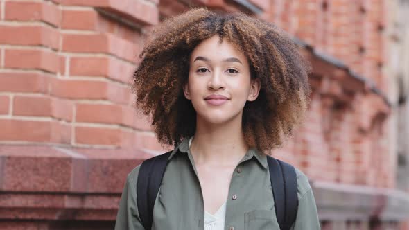 Head Shot Smiling Beautiful Young African Woman Taking Off Protective Facial Medical Mask Deeply