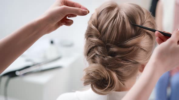 Close Up Hands of Hair Stylist Making Volumizing on Plaited Hairstyle