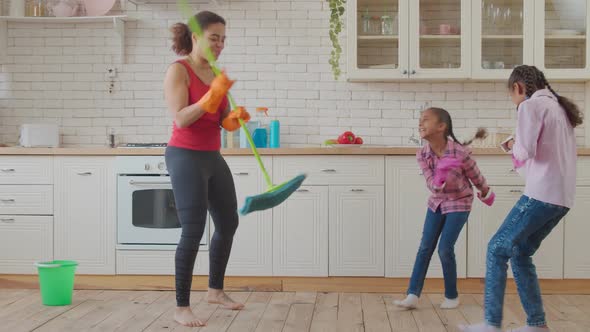 Joyful Family with Kids Having Fun During Cleaning