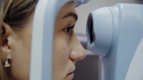 The Ophthalmologist Examines the Patient's Eye and Then Looks Into the Camera