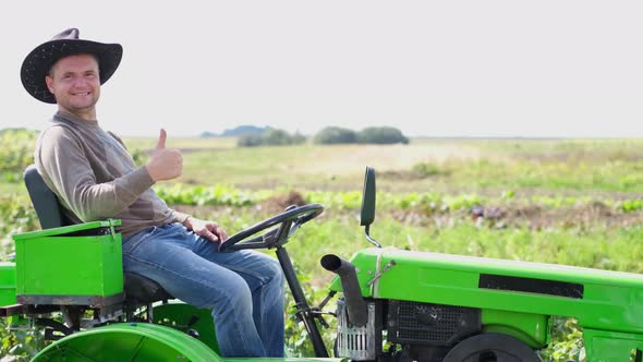 Happy Farmer Near His Green Tractor