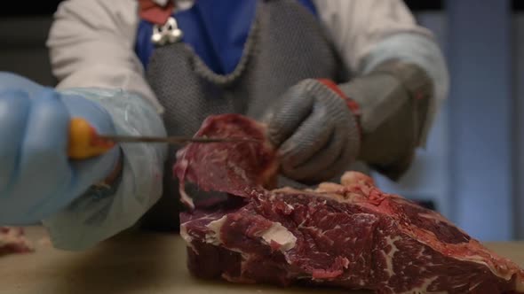 Butcher Cuts Fresh Beef Meat Into Portions Using Sharped Butcher Knife Meat Production and Food