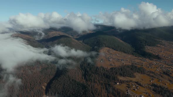 Aerial Bird Eye View of Houses in Mountain Village Arrounded Spruce Forest on Mountain Hills at