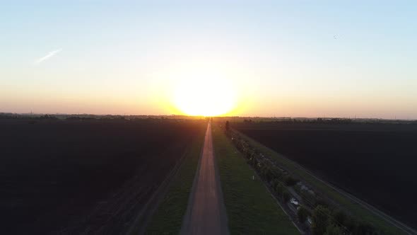 Rural Road in the Background of Sunset or Sunrise