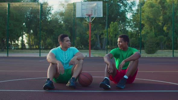 Chatting Streetball Players Relaxing After Game