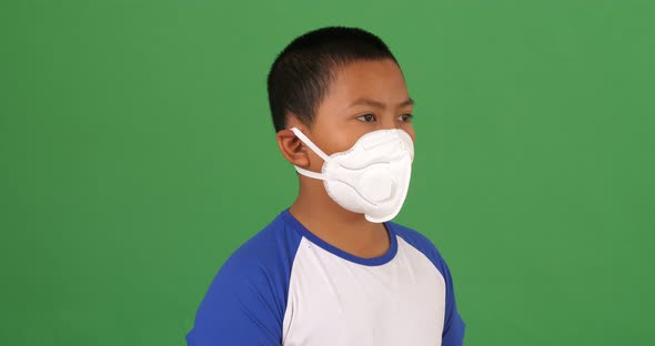 Young Man Wearing Pollution Mask On A Green Screen